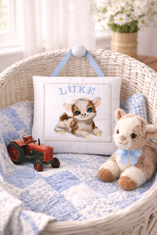 Baby basket with personalized music box pillow, stuffed animal, and toy tractor.