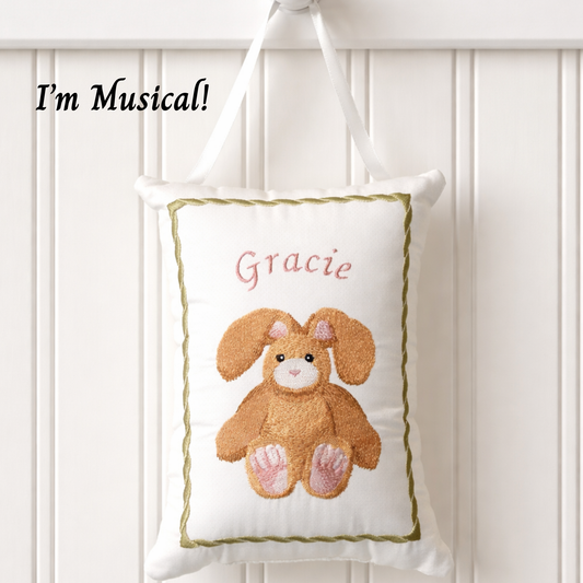 Decorative music box pillow with a bunny design and the name 'Gracie' on a white background.