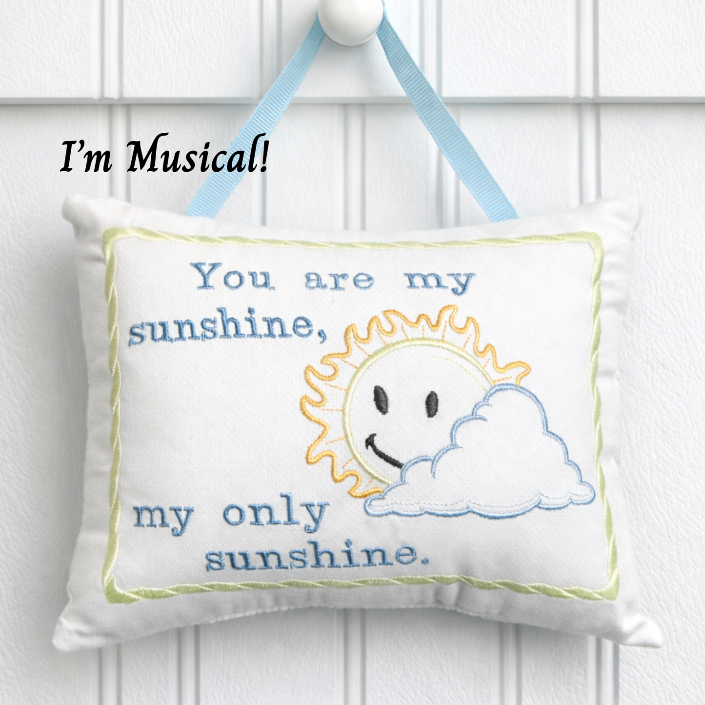 Music box pillow with sun and cloud design and text 'You are my sunshine, my only sunshine.'