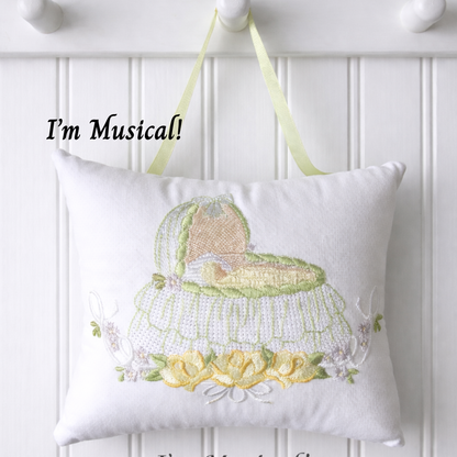 Decorative music box pillow with musical design on a white wall.
