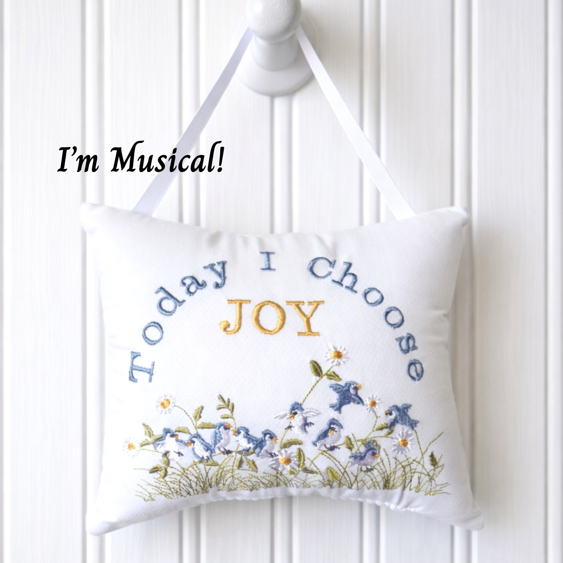 Decorative music box pillow with 'Today I Choose Joy' text and floral design on a white background