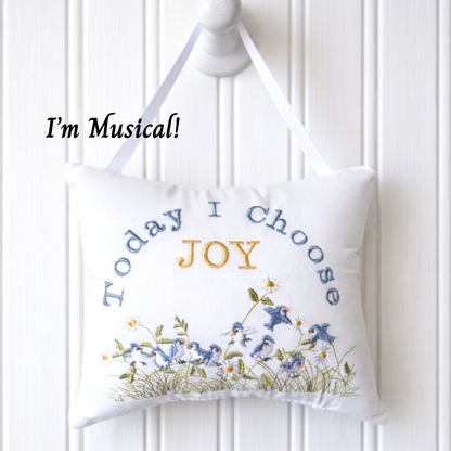 Decorative music box pillow with 'Today I Choose Joy' text and floral design on a white background
