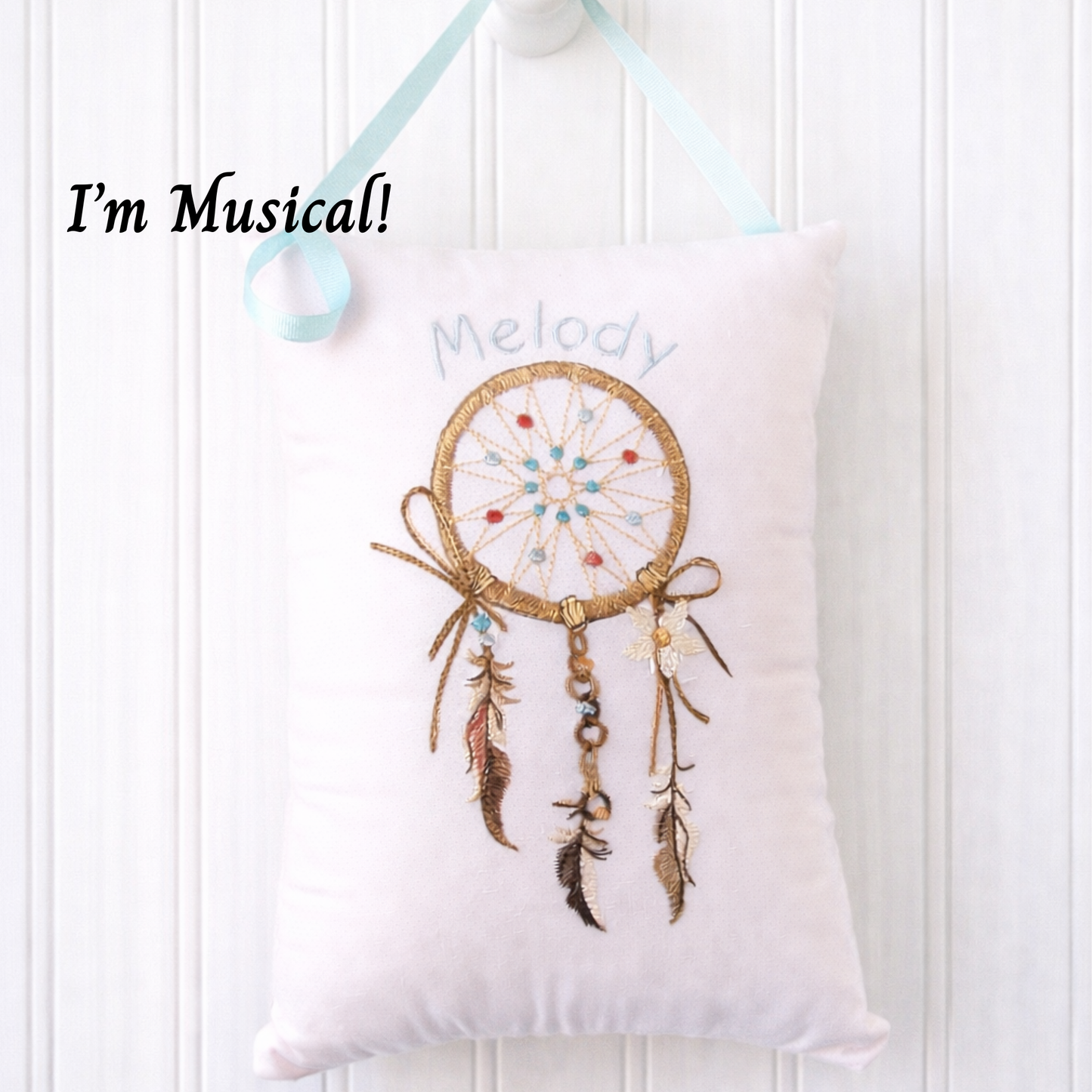 Decorative  music box pillow with a dreamcatcher design and text 'I'm Musical! Melody' on a white background.