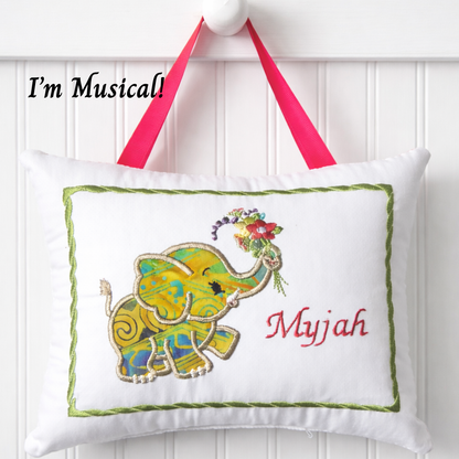 Decorative music box pillow with a colorful elephant design and the name 'Myjah' on a white background.