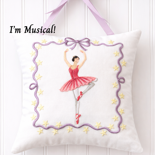 Decorative music box pillow with embroidered ballerina design and text 'I'm Musical!' on a white background.
