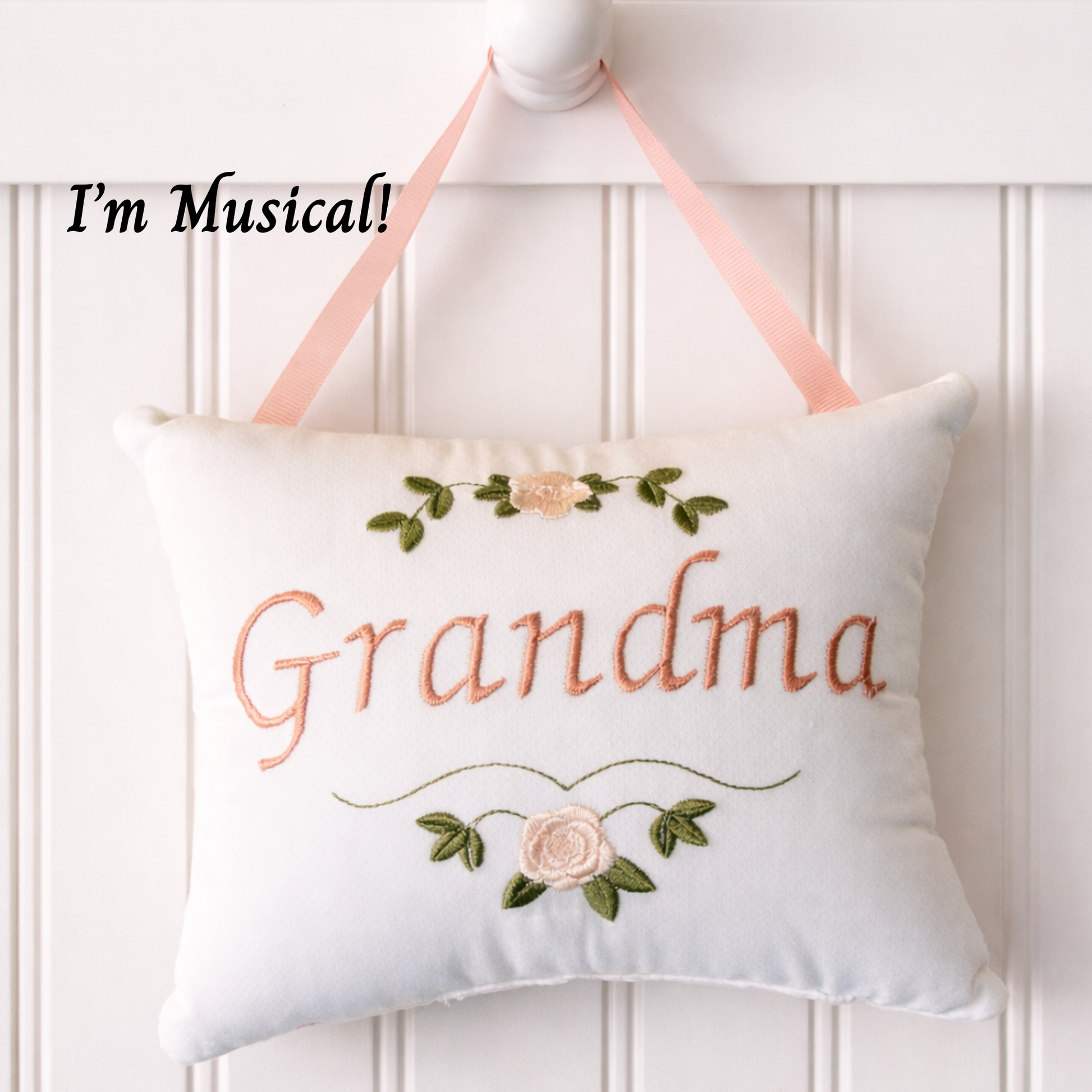 Decorative music box pillow with 'Grandma' embroidery on a white background